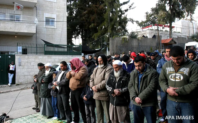.Palestinians attend Friday prayers outside the Red Cross offices during a protest in east Jerusalem on January 27, 2012 in support with four senior Hamas officials whom Israel has been seeking to expel, sparking concern...