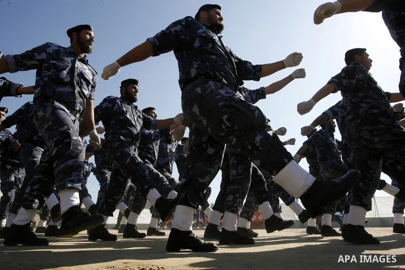 Hamas police officers march in formation during a graduation ceremony from a military course in the southern Gaza Strip city of Khan Yunis on January 29, 2012. Photo by Abed Rahim Khatib