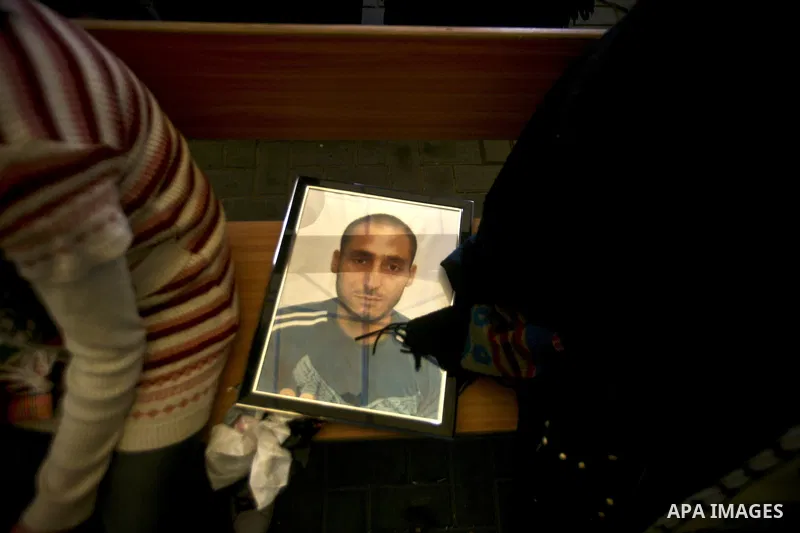 Palestinians hold pictures of their prisoned relatives in Israeli jails as they gather in a weekly activity calling for their liberty at the Red Cross headquarters in Gaza City, on Jan. 30, 2012. Photo by Ali Jadallah