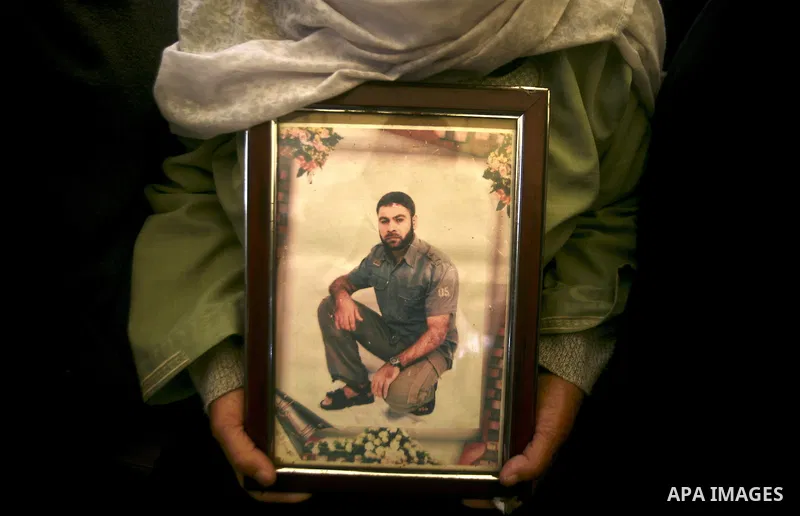 Palestinians hold pictures of their prisoned relatives in Israeli jails as they gather in a weekly activity calling for their liberty at the Red Cross headquarters in Gaza City, on Jan. 30, 2012. Photo by Ali Jadallah