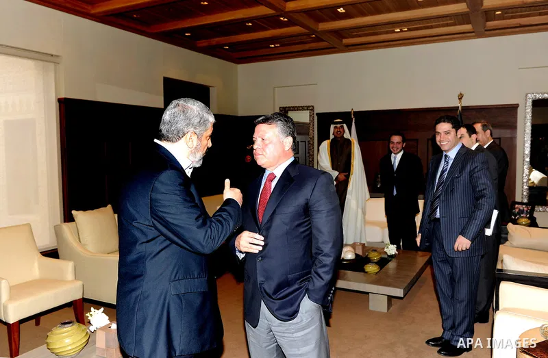 Jordan's King Abdullah (R) chats with senior Hamas leader Khaled Meshaal on his arrival at the Royal Palace in Amman January 29, 2012. Meshaal on Sunday made his first official visit to Jordan since the kingdom expelled...