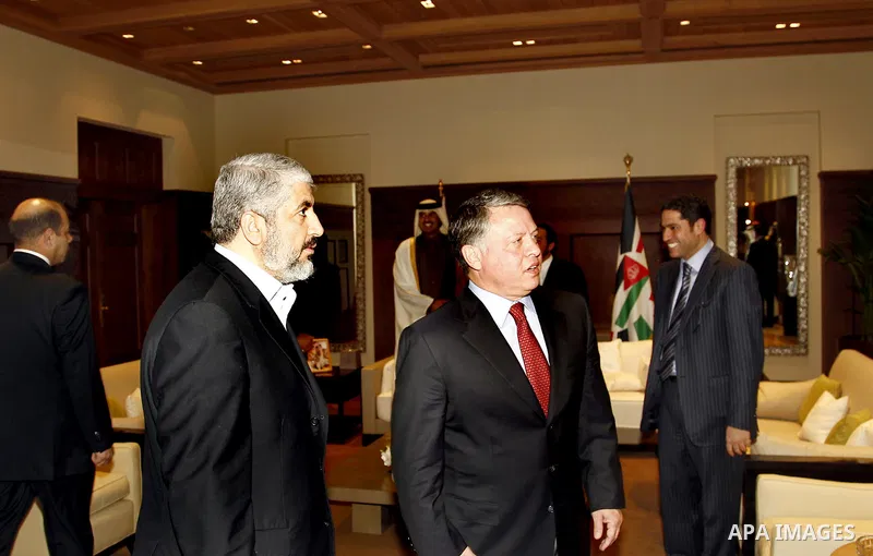 Jordan's King Abdullah (R) chats with senior Hamas leader Khaled Meshaal on his arrival at the Royal Palace in Amman January 29, 2012. Meshaal on Sunday made his first official visit to Jordan since the kingdom expelled...