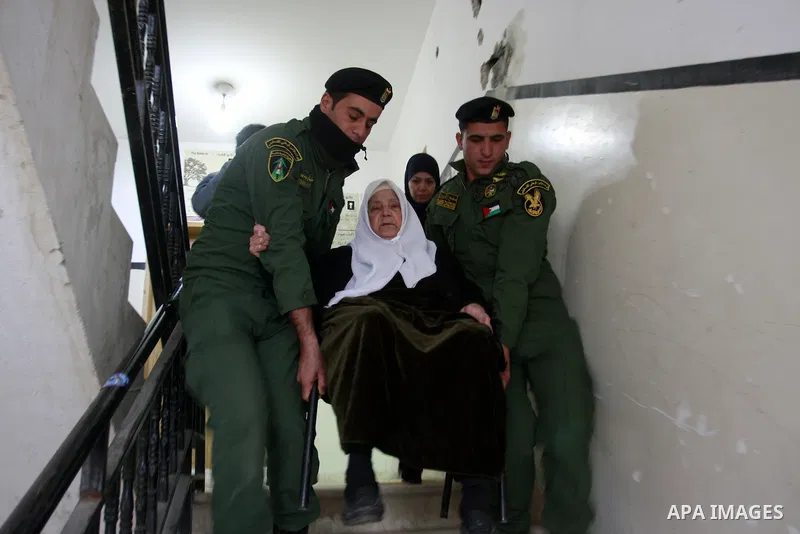 Palestinian National Security forces help patients during working day the medical camp in his court in the West Bank city of Nablus, Jan. 30, 2012. Photo by Wagdi Eshtayah.