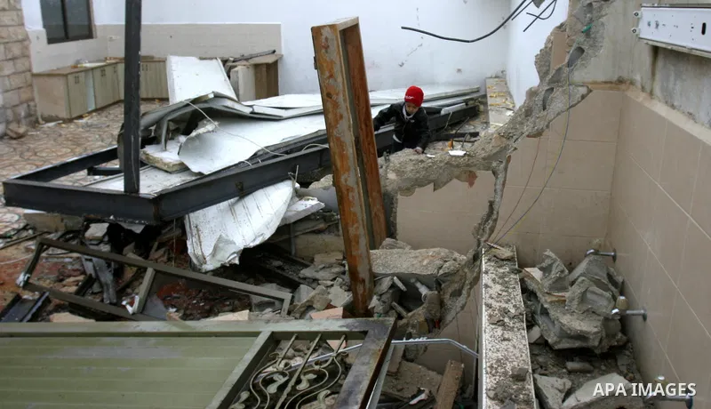 A Palestinian boy inspects the rubble of a home after it was demolished by Israeli bulldozers in the Arab east Jerusalem neighbourhood of Beit Hanina on January 30, 2012. Israel regularly demolishes homes in Arab east Je...