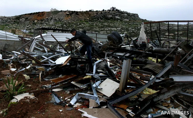 A Palestinian boy inspects the rubble of a home after it was demolished by Israeli bulldozers in the Arab east Jerusalem neighbourhood of Beit Hanina on January 30, 2012. Israel regularly demolishes homes in Arab east Je...