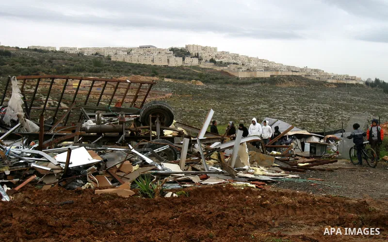 A Palestinian woman inspects the rubble of a home after it was demolished by Israeli bulldozers in the Arab east Jerusalem neighbourhood of Beit Hanina on January 30, 2012. Israel regularly demolishes homes in Arab east...