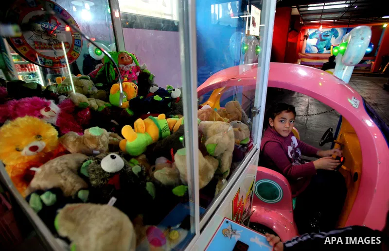 Palestinians children enjoy a ride in an amusement park, during School holidays in Gaza City, Jan. 30, 2012. Photo by Ashraf Amra