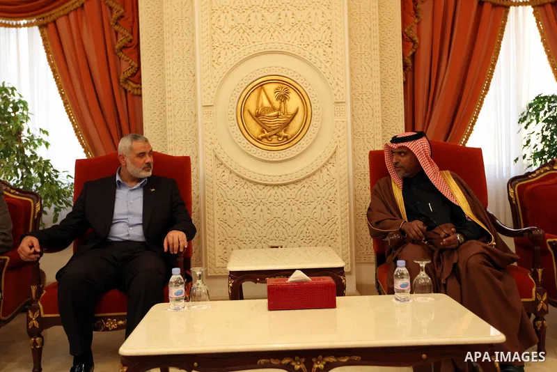 Palestinian Prime Minister in Gaza Strip, Ismail Haniya, is welcomed by an unidentified Qatari official upon his arrival on January 30, 2012 in Doha, the first leg of a regional tour expected to include stops in Iran and...