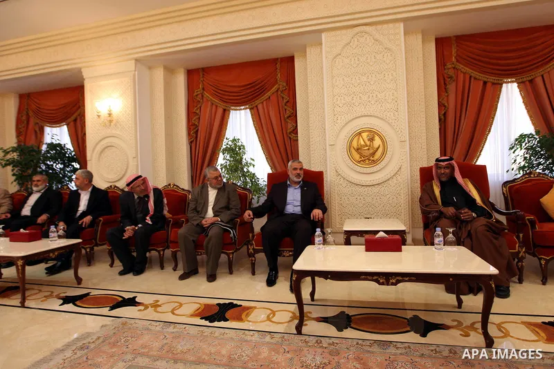 Palestinian Prime Minister in Gaza Strip, Ismail Haniya, is welcomed by an unidentified Qatari official upon his arrival on January 30, 2012 in Doha, the first leg of a regional tour expected to include stops in Iran and...
