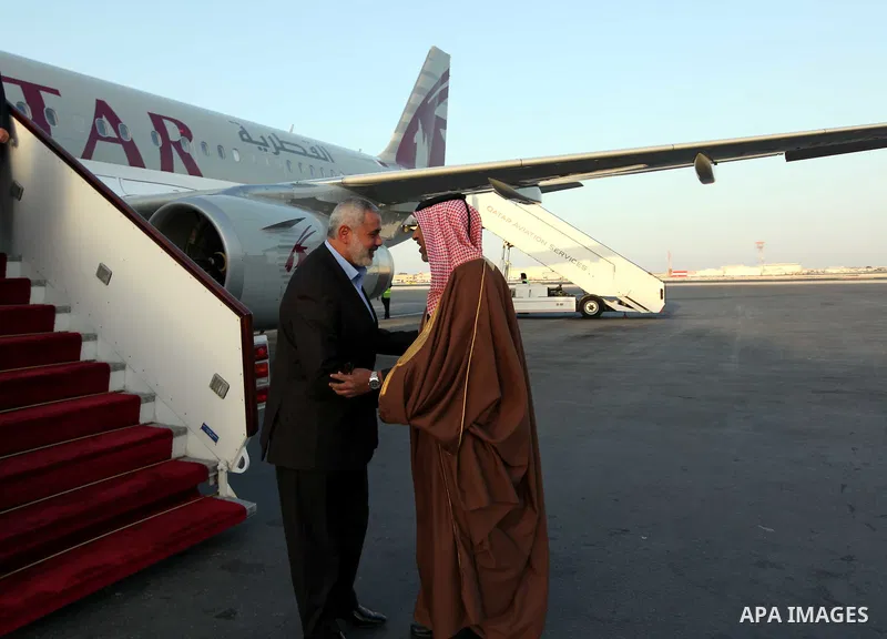 Palestinian Prime Minister in Gaza Strip, Ismail Haniya, is welcomed by an unidentified Qatari official upon his arrival on January 30, 2012 in Doha, the first leg of a regional tour expected to include stops in Iran and...