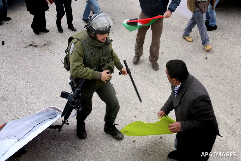 Palestinian protesters argue with Israeli soldiers during a demonstration by Palestinian and foreign activists who tried to reach Route 60, the main Jewish settler road in the West Bank, to protest against Israeli curbs...