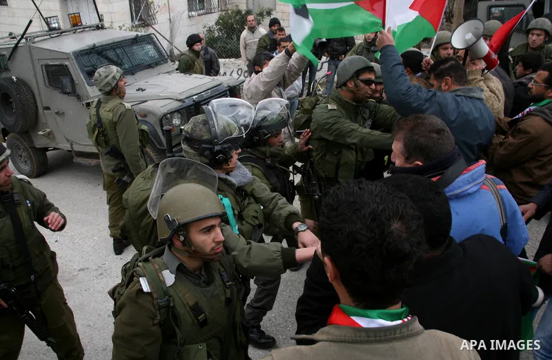 Palestinian protesters argue with Israeli soldiers during a demonstration by Palestinian and foreign activists who tried to reach Route 60, the main Jewish settler road in the West Bank, to protest against Israeli curbs...