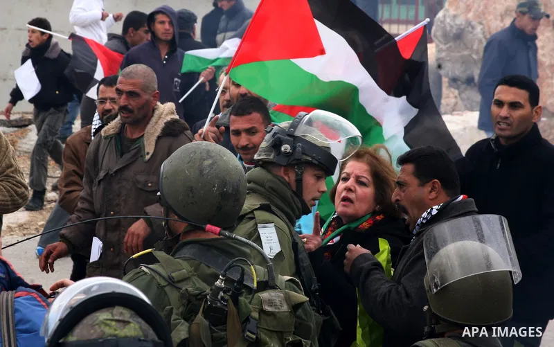 Palestinian protesters argue with Israeli soldiers during a demonstration by Palestinian and foreign activists who tried to reach Route 60, the main Jewish settler road in the West Bank, to protest against Israeli curbs...
