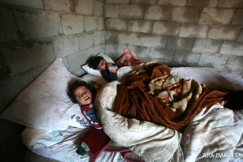 Palestinian children, from a Bedouin family,sleep during low winter temperatures inside their family's tent in Gaza's Zeitoun neighbourhood January 31, 2012. Photo by Mahmud Nassar