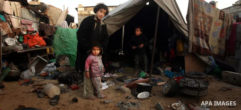 Palestinian children, from a Bedouin family, paly during low winter temperatures inside their family's tent in Gaza's Zeitoun neighbourhood January 31, 2012. Photo by Mahmud Nassar