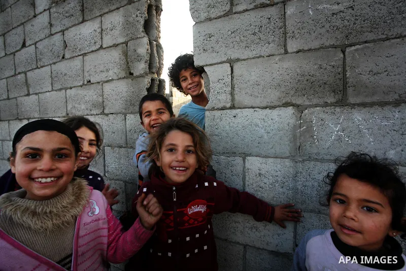 Palestinian children, from a Bedouin family, paly during low winter temperatures inside their family's tent in Gaza's Zeitoun neighbourhood January 31, 2012. Photo by Mahmud Nassar