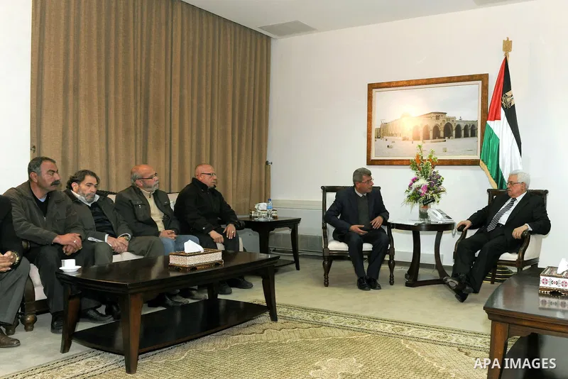 Palestinian President, Mahmoud Abbas (Abu Mazen), meets with prisoners who released in a recent swap between Hamas and Israel, in the West Bank city of Ramallah on Jan. 31, 2012. photo by Thaer Ganaim