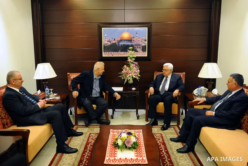Palestinian President, Mahmoud Abbas (Abu Mazen), meets with Chairman of the Central Election Commission, in the West Bank city of Ramallah on Jan. 31, 2012. photo by Thaer Ganaim