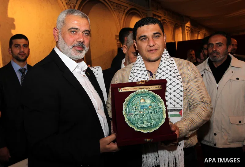 Palestinian Prime Minister in Gaza Strip, Ismail Haniyah receives released prisoners, deported to the Qatar, in the Qatari capital of Doha on Jan. 31,2012. photo by Mohammed Al-Ostaz