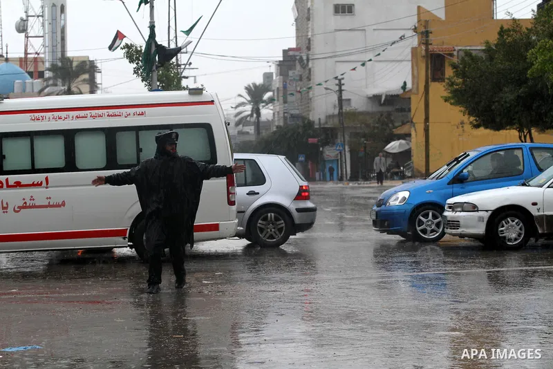 Palestinian policemen organize the traffic during the heavy rain of the winter, in the Gaza City, Feb. 01, 2012. Photo by Mohammed Asad