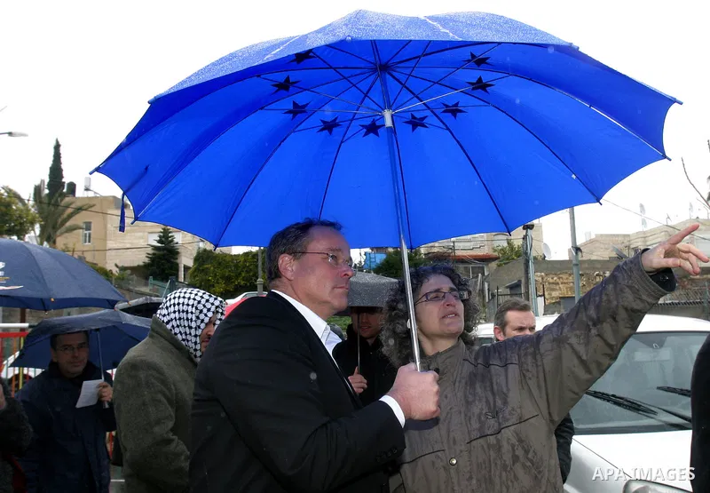 Germany's Minister for Economic Cooperation and Development Dirk Niebel speaks with a local dignitary during a visit to the Palestinian in silwan neighbourhood of jerusalem, on february 1, 2012. Photo by Mahfouz Abu Turk