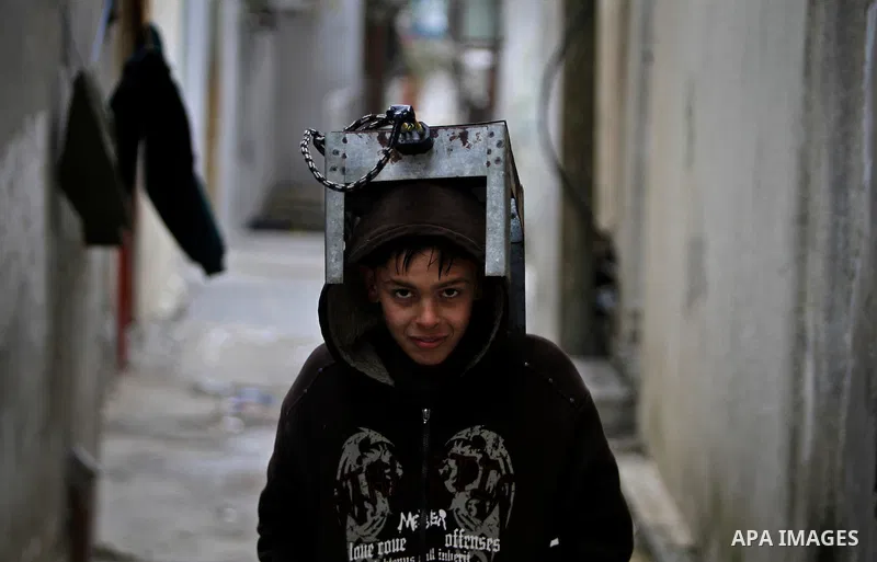 Palestinian children walk in a street during the heavy rain of the winter, in the Gaza City, Feb. 01, 2012. Photo by Ali Jadallah