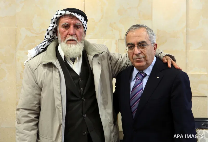 Palestinian Prime Minister, Salam Fayyad receives The prisoner father, Adnan al-Khader, in the West Bank City or Ramallah, on Feb. 02, 2012. Photo by Mustafa Abu Dayeh