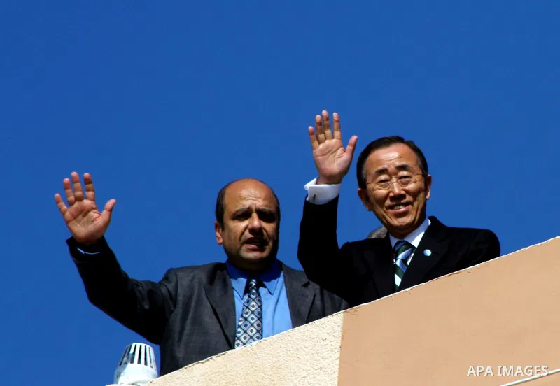 UN secretary general Ban Ki-moon waves during a visit to the construction site of a housing project in Khan Yunis in the southern Gaza Strip on February 2, 2012. Protesters threw shoes, sand and small stones at the convo...