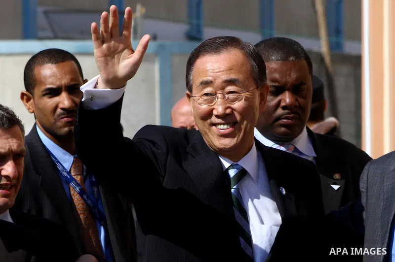 UN secretary general Ban Ki-moon waves during a visit to the construction site of a housing project in Khan Yunis in the southern Gaza Strip on February 2, 2012. Protesters threw shoes, sand and small stones at the convo...