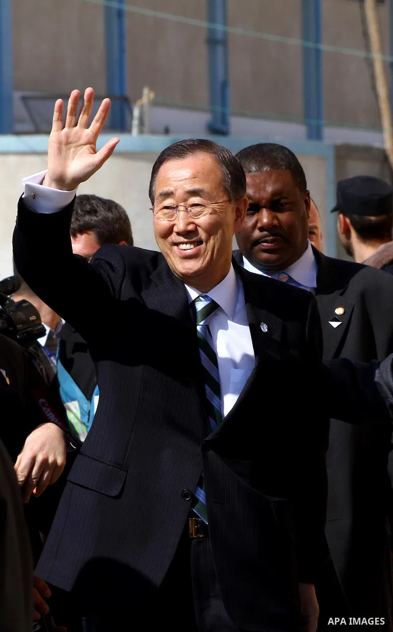 UN secretary general Ban Ki-moon waves during a visit to the construction site of a housing project in Khan Yunis in the southern Gaza Strip on February 2, 2012. Protesters threw shoes, sand and small stones at the convo...