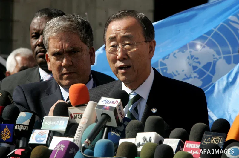 UN secretary general Ban Ki-moon waves during a visit to the construction site of a housing project in Khan Yunis in the southern Gaza Strip on February 2, 2012. Protesters threw shoes, sand and small stones at the convo...