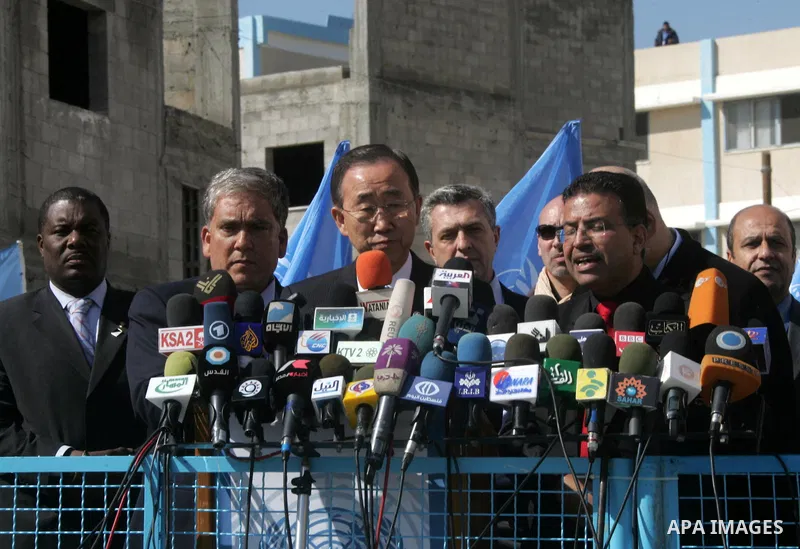 UN secretary general Ban Ki-moon waves during a visit to the construction site of a housing project in Khan Yunis in the southern Gaza Strip on February 2, 2012. Protesters threw shoes, sand and small stones at the convo...