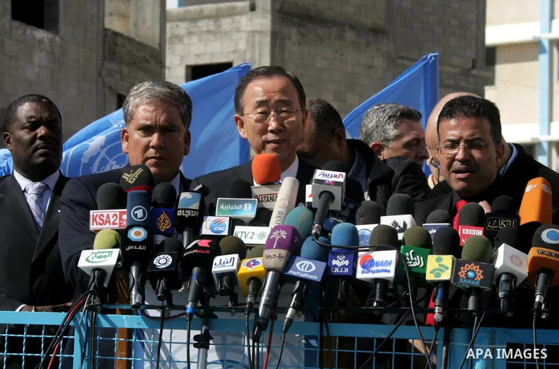UN secretary general Ban Ki-moon waves during a visit to the construction site of a housing project in Khan Yunis in the southern Gaza Strip on February 2, 2012. Protesters threw shoes, sand and small stones at the convo...
