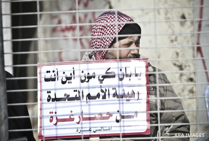 Palestinians demonstrate before the arrival of UN Secretary-General Ban Ki-moon at the Erez checkpoint in the northern Gaza Strip on February 2, 2012. Protesters threw shoes, sand and small stones at his convoy, which wa...