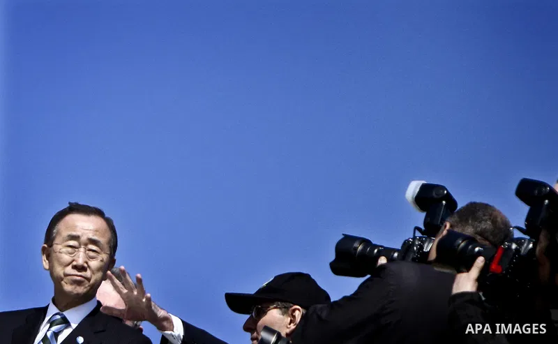 UN secretary general Ban Ki-moon waves during a visit to the construction site of a housing project in Khan Yunis in the southern Gaza Strip on February 2, 2012. Protesters threw shoes, sand and small stones at the convo...