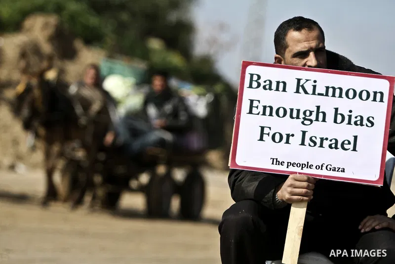 Palestinians demonstrate before the arrival of UN Secretary-General Ban Ki-moon at the Erez checkpoint in the northern Gaza Strip on February 2, 2012. Protesters threw shoes, sand and small stones at his convoy, which wa...