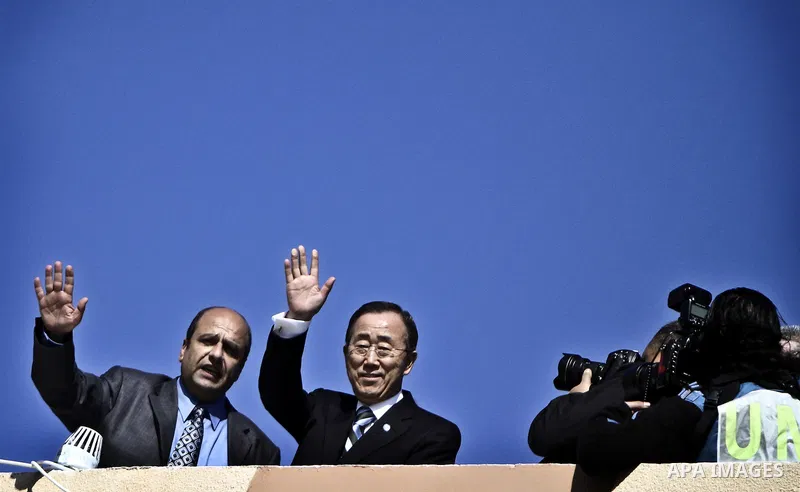UN secretary general Ban Ki-moon waves during a visit to the construction site of a housing project in Khan Yunis in the southern Gaza Strip on February 2, 2012. Protesters threw shoes, sand and small stones at the convo...