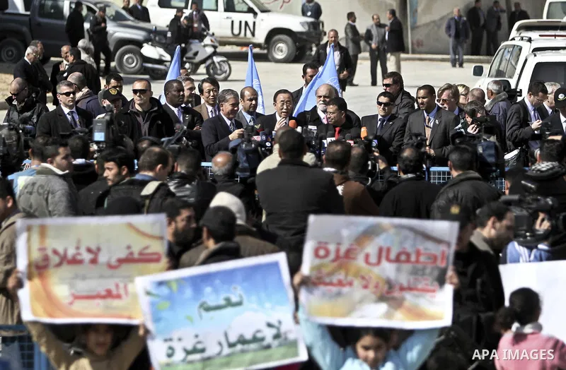 UN secretary general Ban Ki-moon speaks during a press conference as he visits the construction site of a housing project in Khan Yunis in the southern Gaza Strip on February 2, 2012. Protesters threw shoes, sand and sma...