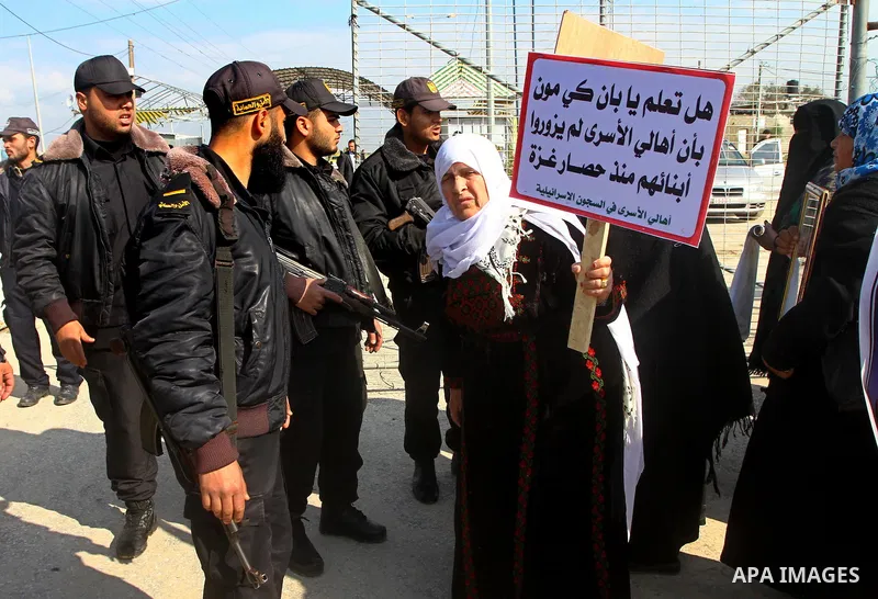 Palestinians demonstrate before the arrival of UN Secretary-General Ban Ki-moon at the Erez checkpoint in the northern Gaza Strip on February 2, 2012. Protesters threw shoes, sand and small stones at his convoy, which wa...