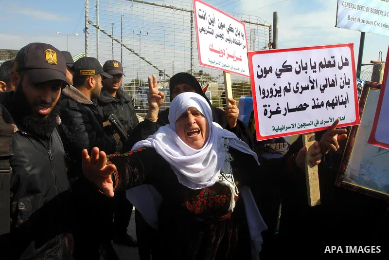 Palestinians demonstrate before the arrival of UN Secretary-General Ban Ki-moon at the Erez checkpoint in the northern Gaza Strip on February 2, 2012. Protesters threw shoes, sand and small stones at his convoy, which wa...