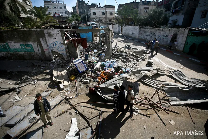 Palestian boys stand next to a destroyed house after an Israeli airstrike in Beit Lahiya town in the northern Gaza Strip, 03 February 2012. Two Palestinians were wounded by Israeli air-strikes in the Gaza Strip. . Photo...