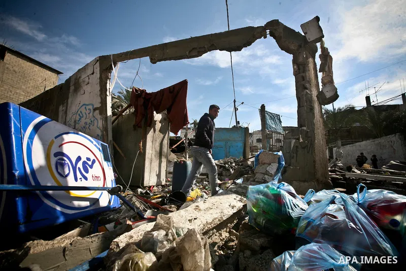 Palestian boys stand next to a destroyed house after an Israeli airstrike in Beit Lahiya town in the northern Gaza Strip, 03 February 2012. Two Palestinians were wounded by Israeli air-strikes in the Gaza Strip. . Photo...
