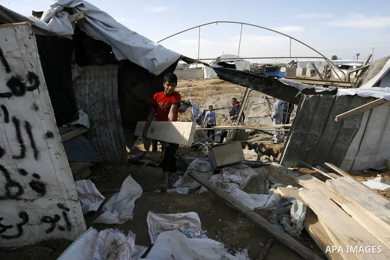 Palestinians survey the damage to a smuggling tunnel after it was targeted in an Israeli air strike in Rafah, in the southern Gaza Strip on February 3, 2012. Two Palestinians in the Gaza Strip were wounded by Israeli air...