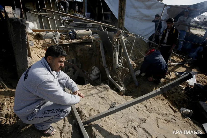 Palestinians survey the damage to a smuggling tunnel after it was targeted in an Israeli air strike in Rafah, in the southern Gaza Strip on February 3, 2012. Two Palestinians in the Gaza Strip were wounded by Israeli air...