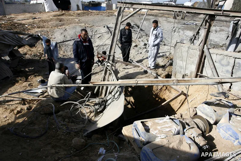 Palestinians survey the damage to a smuggling tunnel after it was targeted in an Israeli air strike in Rafah, in the southern Gaza Strip on February 3, 2012. Two Palestinians in the Gaza Strip were wounded by Israeli air...