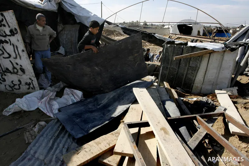 Palestinians survey the damage to a smuggling tunnel after it was targeted in an Israeli air strike in Rafah, in the southern Gaza Strip on February 3, 2012. Two Palestinians in the Gaza Strip were wounded by Israeli air...