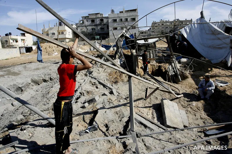 Palestinians survey the damage to a smuggling tunnel after it was targeted in an Israeli air strike in Rafah, in the southern Gaza Strip on February 3, 2012. Two Palestinians in the Gaza Strip were wounded by Israeli air...