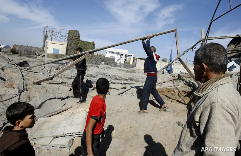 Palestinians survey the damage to a smuggling tunnel after it was targeted in an Israeli air strike in Rafah, in the southern Gaza Strip on February 3, 2012. Two Palestinians in the Gaza Strip were wounded by Israeli air...
