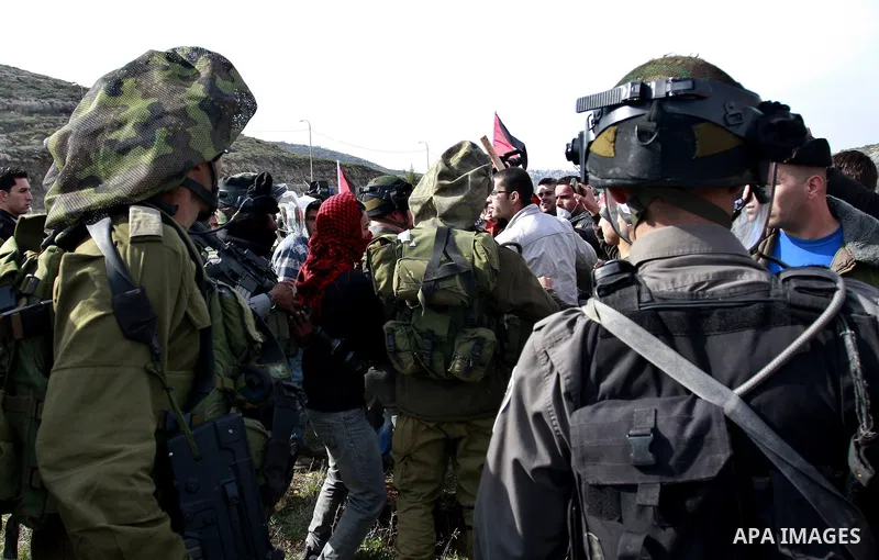 Israeli troops stop palestinian demonstrators during a protest in the Village Qaryut , near the Israeli settlement of Ali, in the northern West Bank, Friday, Feb. 03, 2012. Photo by Wagdi Eshtayah