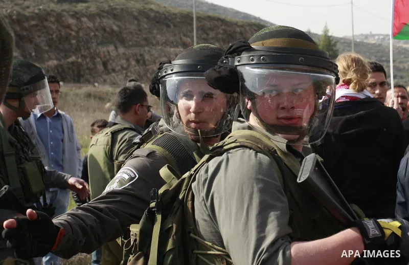 Israeli troops stop palestinian demonstrators during a protest in the Village Qaryut , near the Israeli settlement of Ali, in the northern West Bank, Friday, Feb. 03, 2012. Photo by Wagdi Eshtayah